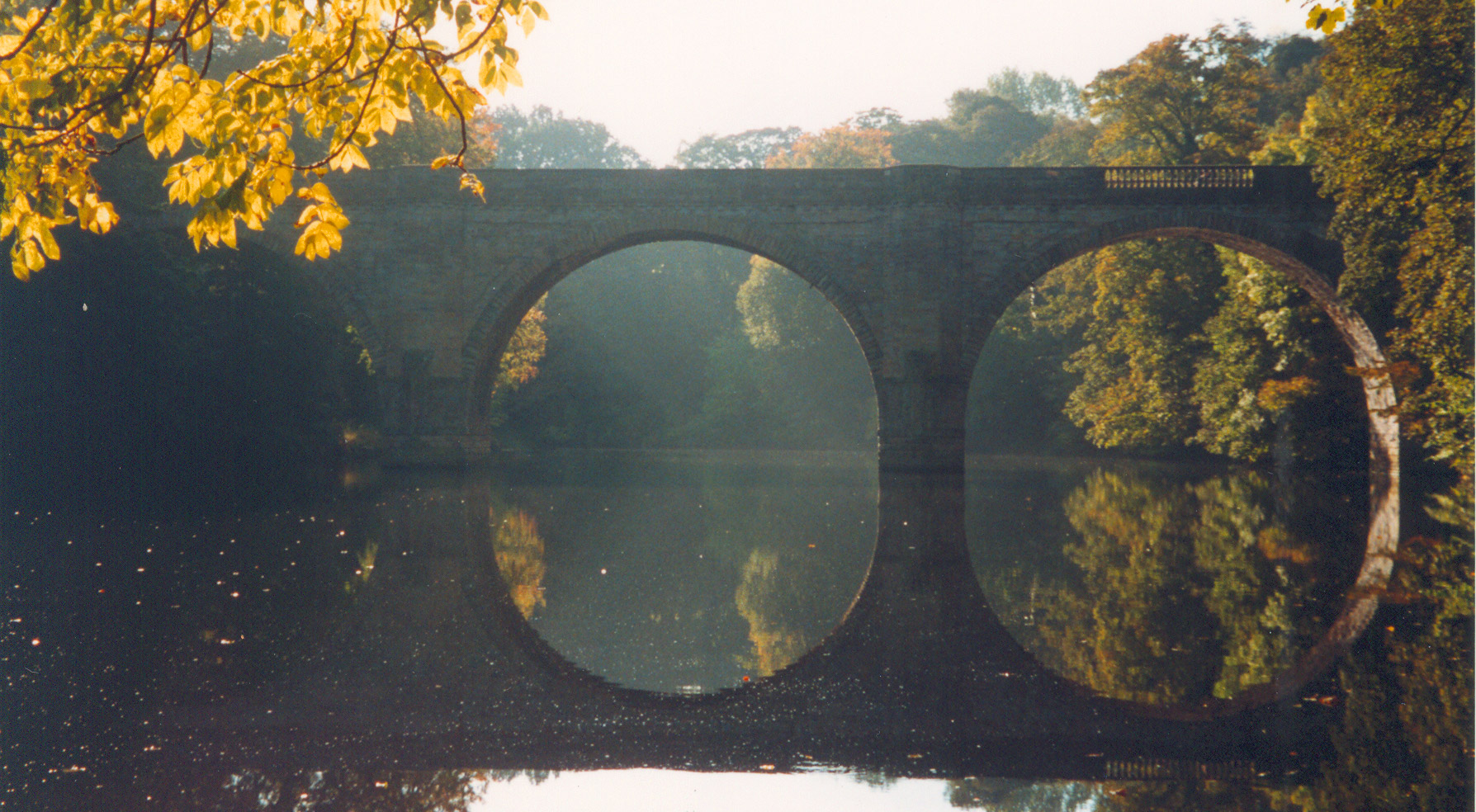 Prebends' Bridge reflected in the River Wear with autumnal trees