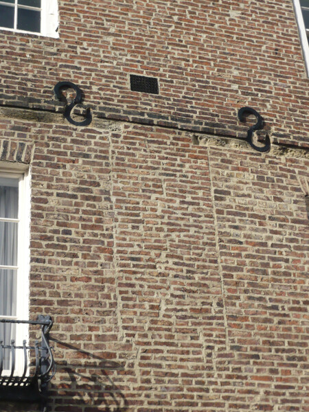 This blocked window on North Bailey indicates a change of use. Many of the buildings on this street started life as residential structures, but now house Durham University Departments. The iron s-shapes on the facade are structural braces, added to the building at some point to control movement or subsidence of the walls.