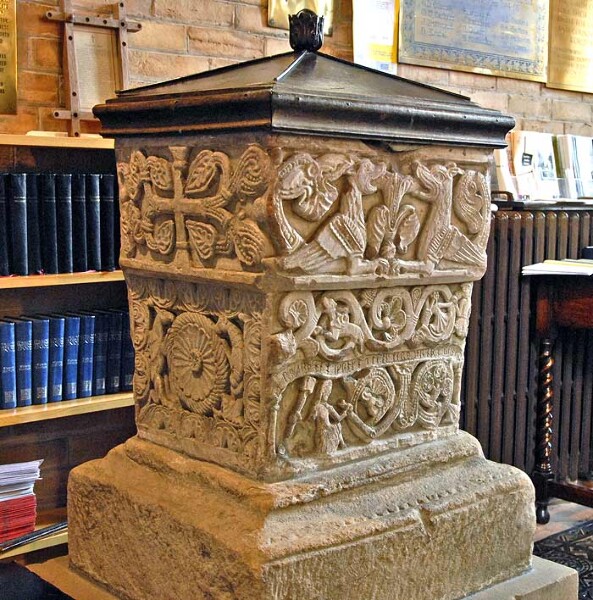 The Norman font at St. Bridget's Church in BrideKirk, a good example of Anglo-Norman stone carving