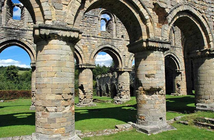 A view of the ruins of Buildwas Abbey in Shropshire, showing the massive stone columns typical of Romanesque architecture