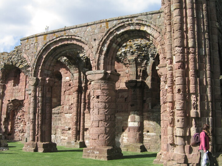View of the ruins of Lindisfarne Priory. The arcades, especially the pillars with a chevron or zigzag design are like a scaled-down version of those of Durham Cathedral. This is hardly surprising: The priory was refounded in the early twelfth century by the Durham-based community of St Cuthbert, after the building of the Cathedral. It is possible that the same masons worked on both buildings. 