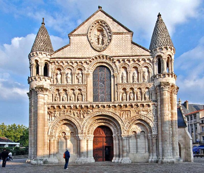 The facade of Notre Dame la Grande, Poitiers, France, 12th century. This facade is a good example of Romanesque architecture in that is very solid, makes use of rows of rounded arches in which figural sculpture is to be found, and features geometric patterns as well. 