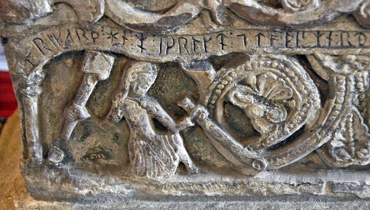 Detail of a stone font dating from circa 1150 and depicting its maker Richard of Durham. In St. Bridget's Church, Bridekirk.