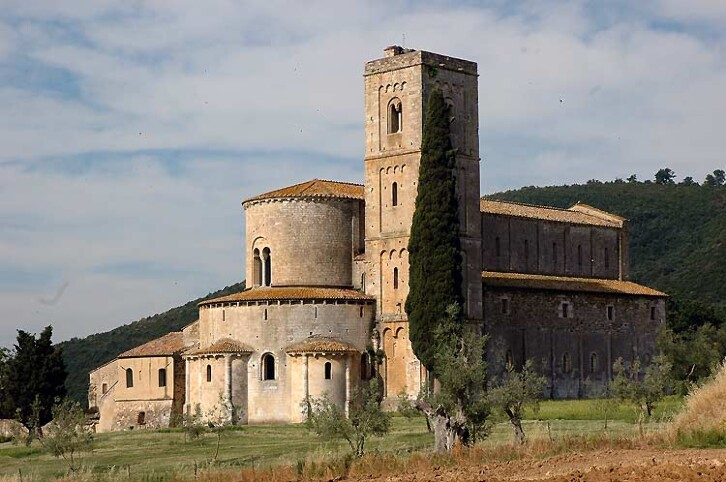 Exterior view of the abbey of Sant Antimo, Tuscany, Italy, 1120. This Benedictine abbey is a text-book example of Romanesque architecture, with its square tower, solid construction, and small, round-arched windows. The abbey here was the most important foundation in Tuscany. It had imperial connections, was on the route to Rome, and had extensive landholdings. It has an interesting historic parallel to Durham. The abbot was so powerful that he held the title of Earl Palatine, and had similar secular authority as the Prince Bishops of Durham.