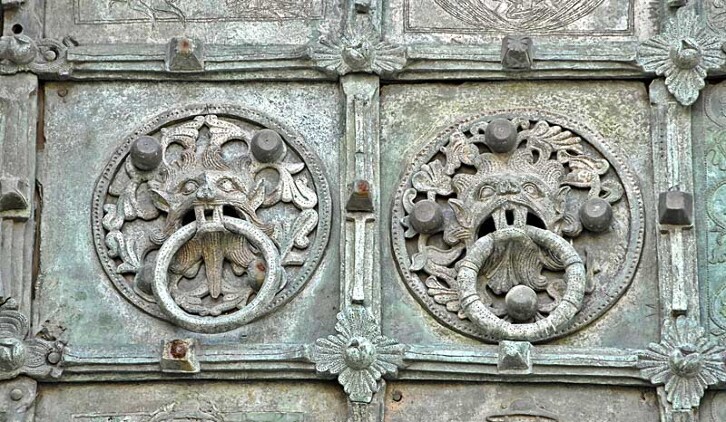 The Bronze door of Troia Cathedral was made by Oderiso di Benevento in 1119. The ringed bosses seen here may not have had the same significance as Durham Cathedral's Sanctuary Knocker, seen in the next image, but they are visually similar. 