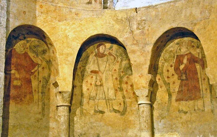 Eleventh century apse in the priory of Villeneuve d'Aveyron in France, decorated with fourteenth century scenes of pilgrims, a reminder of the role such buildings played. 