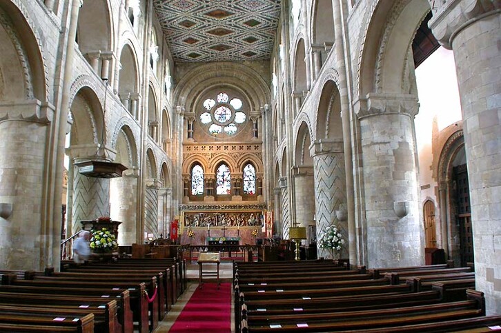 View of the nave of Waltham Abbey, England, mid 12th century. The abbey is contemporary with the nave of Durham Cathedral, and in fact looks quite similar. The stone for the construction was probably imported from Caen in Normandy, a common practise in Norman times, (though not the case in Durham, where the stone was local).  