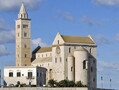 Exterior view of Trani Cathedral, Italy, 1199 onwards. The fact that Romanesque buildings tended to have small windows is very clear in a building like this, which looks almost defensive. 