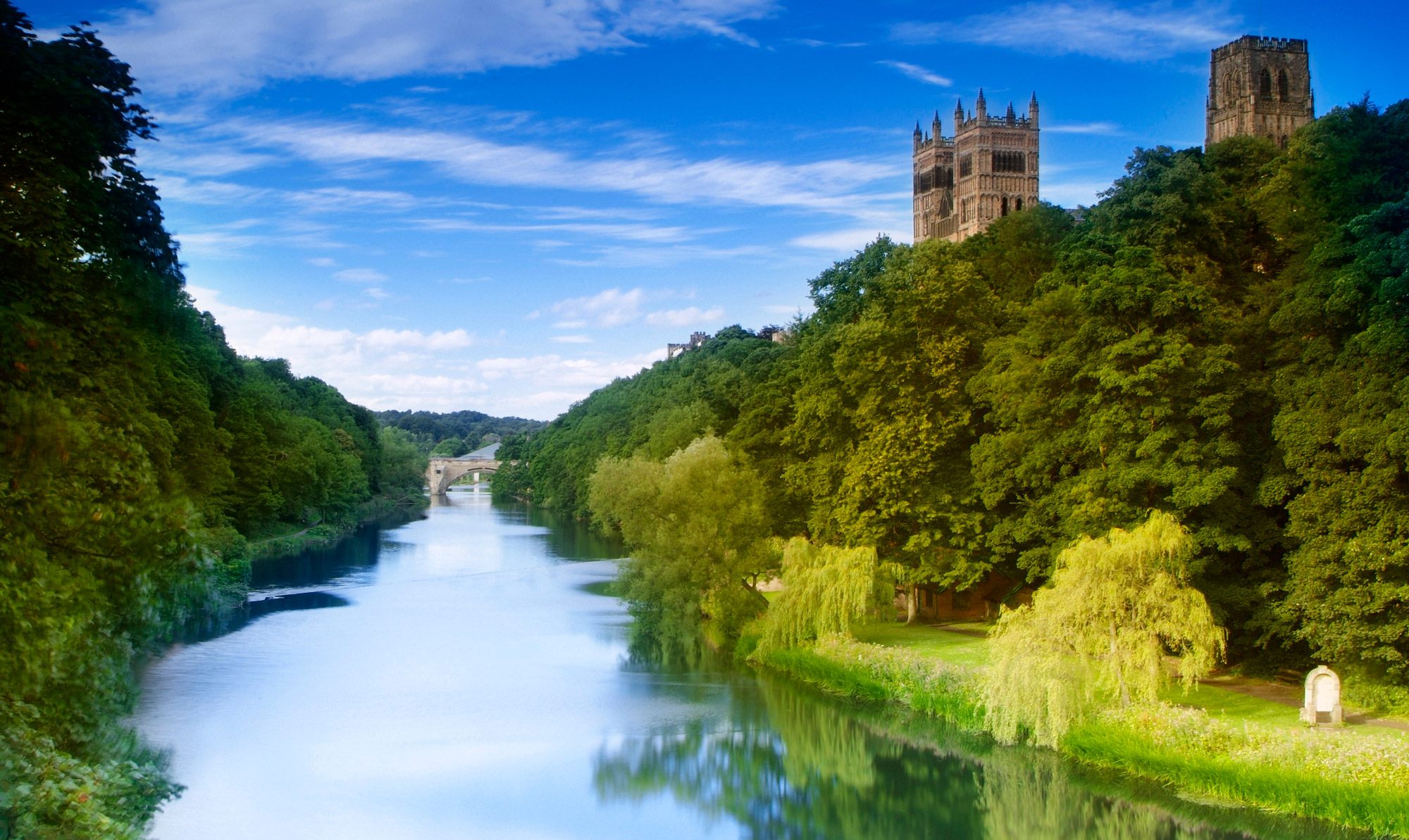 Durham Cathedral sitting high above the River Wear, looking from Prebends' Bridge towards Framwellgate Bridge