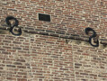 This blocked window on North Bailey indicates a change of use. Many of the buildings on this street started life as residential structures, but now house Durham University Departments. The iron s-shapes on the facade are structural braces, added to the building at some point to control movement or subsidence of the walls.