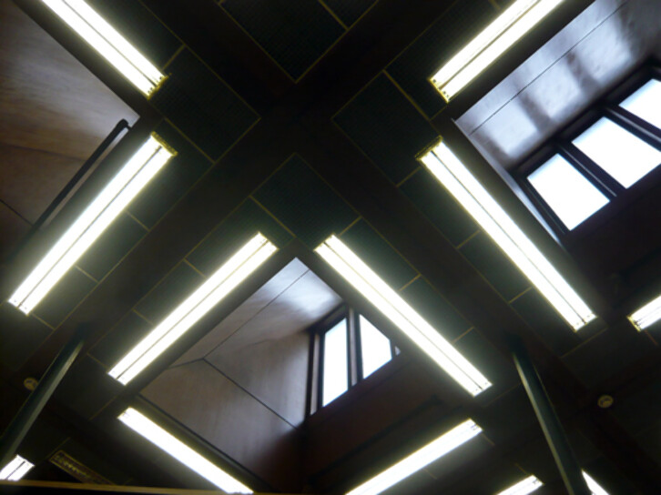 George Pace designed his library extension to maximise the amount of natural light entering the building. He made use of extensive areas of glass on the river front of the building, and numerous skylights in the main reading room, seen here.