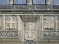 Detail of the facade showing (from left to right) the coats of arms of Van Mildert, the Prince Bishop who founded Durham University; the Bishopric of Durham, Durham University, the City of Durham. The coat of arms to the far right is yet to be identified.  