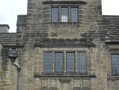 The Pemberton Building shows a Tudor influence. Here, this is seen in the rows of small leaded windows and the shape of the doorway.