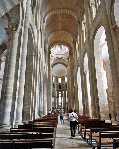 View of the nave of the church of St. Foy at Conques, contemporary with Durham Cathedral. The simple vaults used limited the builders' capacity to span a large width, and therefore the nave it very narrow. It was the use of pointed arches and rib vaults at Durham Cathedral that enabled the construction of a wide nave, and paved the way for the soaring buildings that reached their zenith with Gothic architecture. 