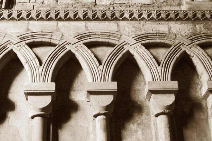 Detail of the intersecting arches in the nave at Durham Cathedral, circa 1100. The similarity of these arches to those in other buildings in Spain is testament to the cross-cultural influences that shaped medieval architecture, sometimes through the movement of craftsmen, at other times, because people travelled and returned home inspired by what they saw abroad.