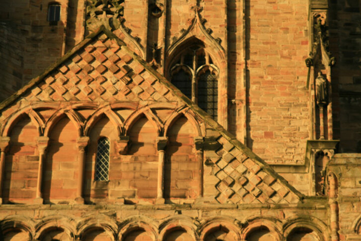 Detail of the stone carving on the exterior of Durham Cathedral. Circa 1100. The use of lozenges (diamond shapes) and intersecting arches was common in Romanesque architecture. (See previous image). The combination of recessed and projecting lozenges, as seen here, would have been especially effective in sunny climates where the contrast between the recesses and the projections would have been striking. This pattern may have been seen in Spain and copied from there.