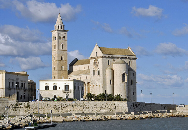 Exterior view of Trani Cathedral, Italy, 1199 onwards. The fact that Romanesque buildings tended to have small windows is very clear in a building like this, which looks almost defensive. 