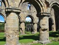 A view of the ruins of Buildwas Abbey in Shropshire, showing the massive stone columns typical of Romanesque architecture