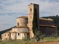 Exterior view of the abbey of Sant Antimo, Tuscany, Italy, 1120. This Benedictine abbey is a text-book example of Romanesque architecture, with its square tower, solid construction, and small, round-arched windows. The abbey here was the most important foundation in Tuscany. It had imperial connections, was on the route to Rome, and had extensive landholdings. It has an interesting historic parallel to Durham. The abbot was so powerful that he held the title of Earl Palatine, and had similar secular authority as the Prince Bishops of Durham.